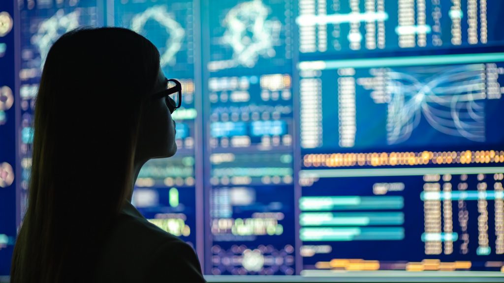 Woman reviewing data display.